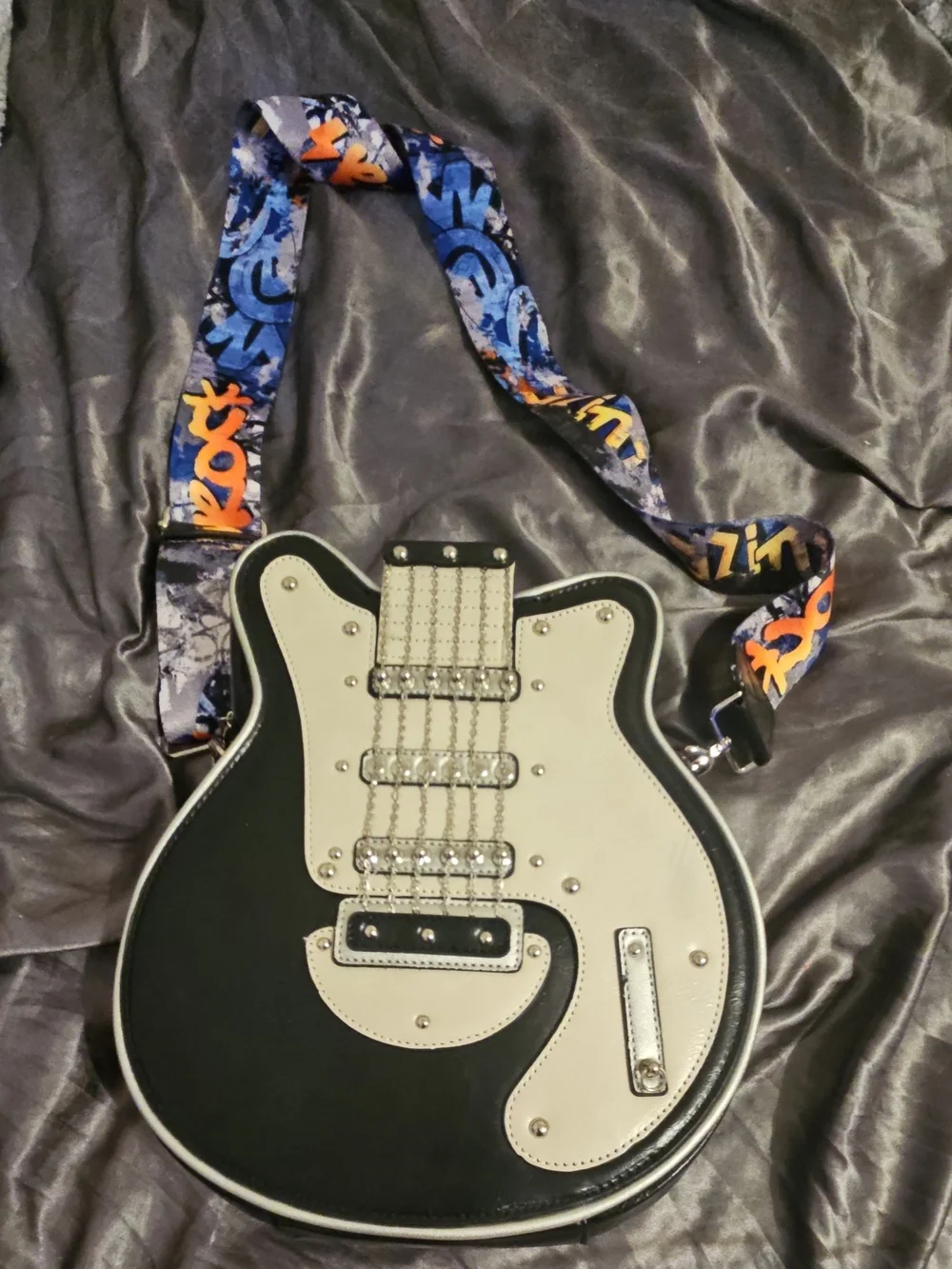 Black and Cream Guitar-Shaped Crossbody Bag with Graphic Strap